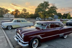 1953 Packard Patrician 4-Door Touring Sedan in Matador Maroon and 1955 Clipper Custom 4-Door Touring Sedan in Yellow and White